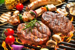 Assorted delicious grilled meat with vegetable over the coals on a barbecue